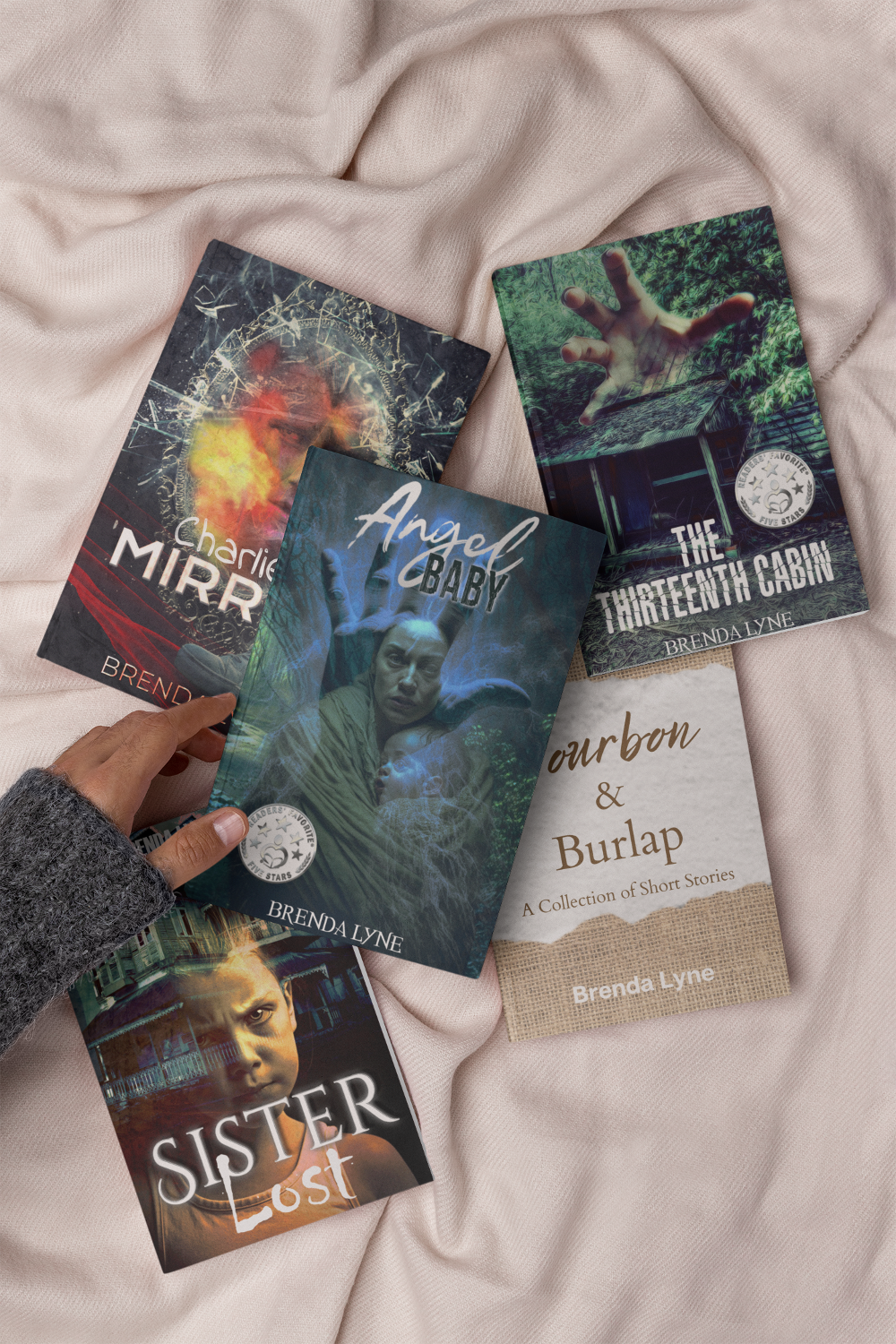 Five paranormal mystery thriller books by Brenda Lyne: Angel Baby, The Thirteenth Cabin, Sister Lost, Charlie's Mirror, Bourbon and Burlap