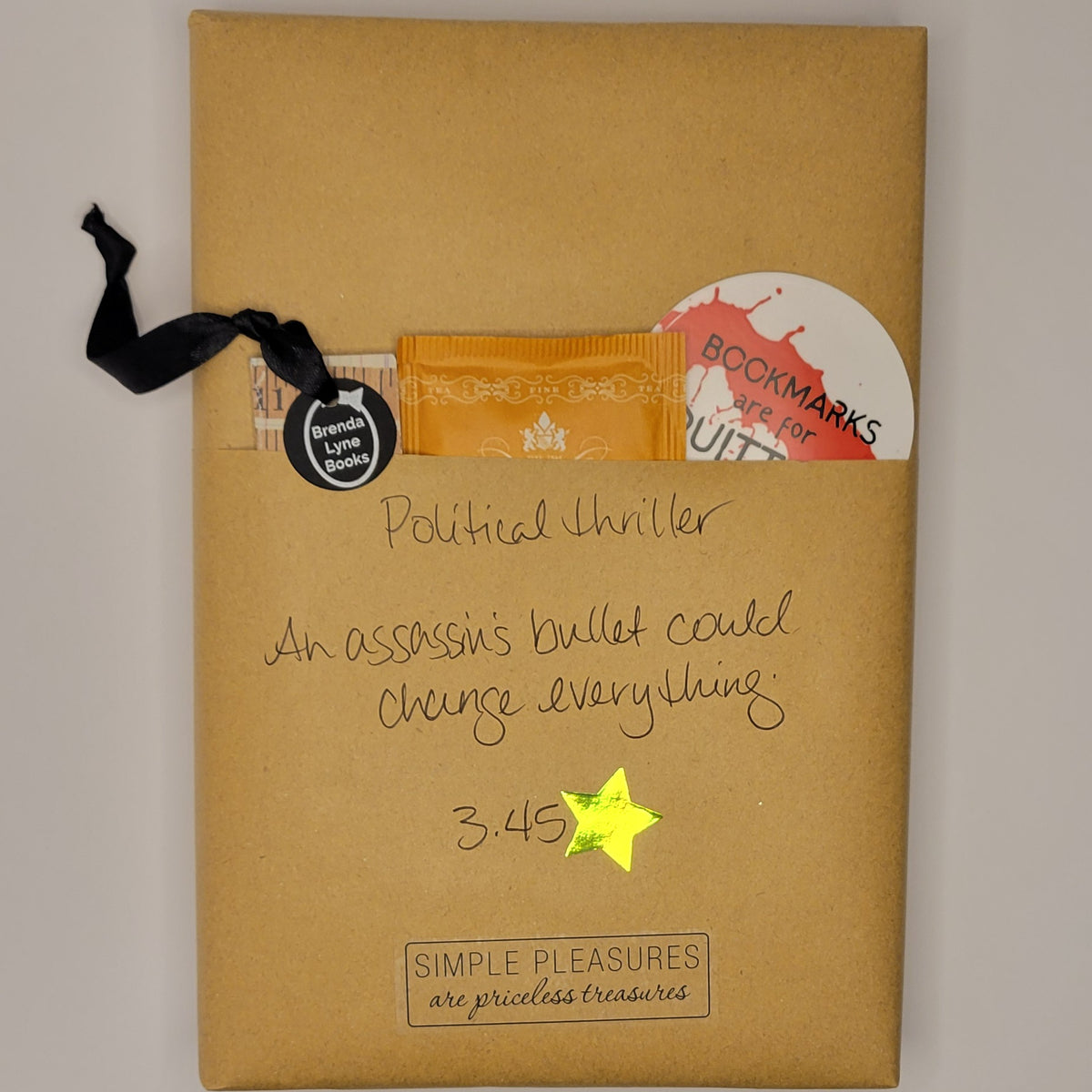 Hardcover book wrapped in brown paper with writing on it and goodies tucked inside.